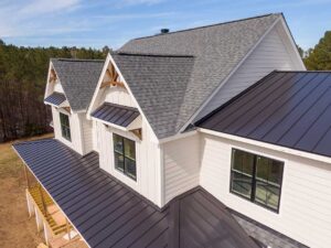 Homeowner inspecting roof shingles from a secured ladder on a dry, sunny day.